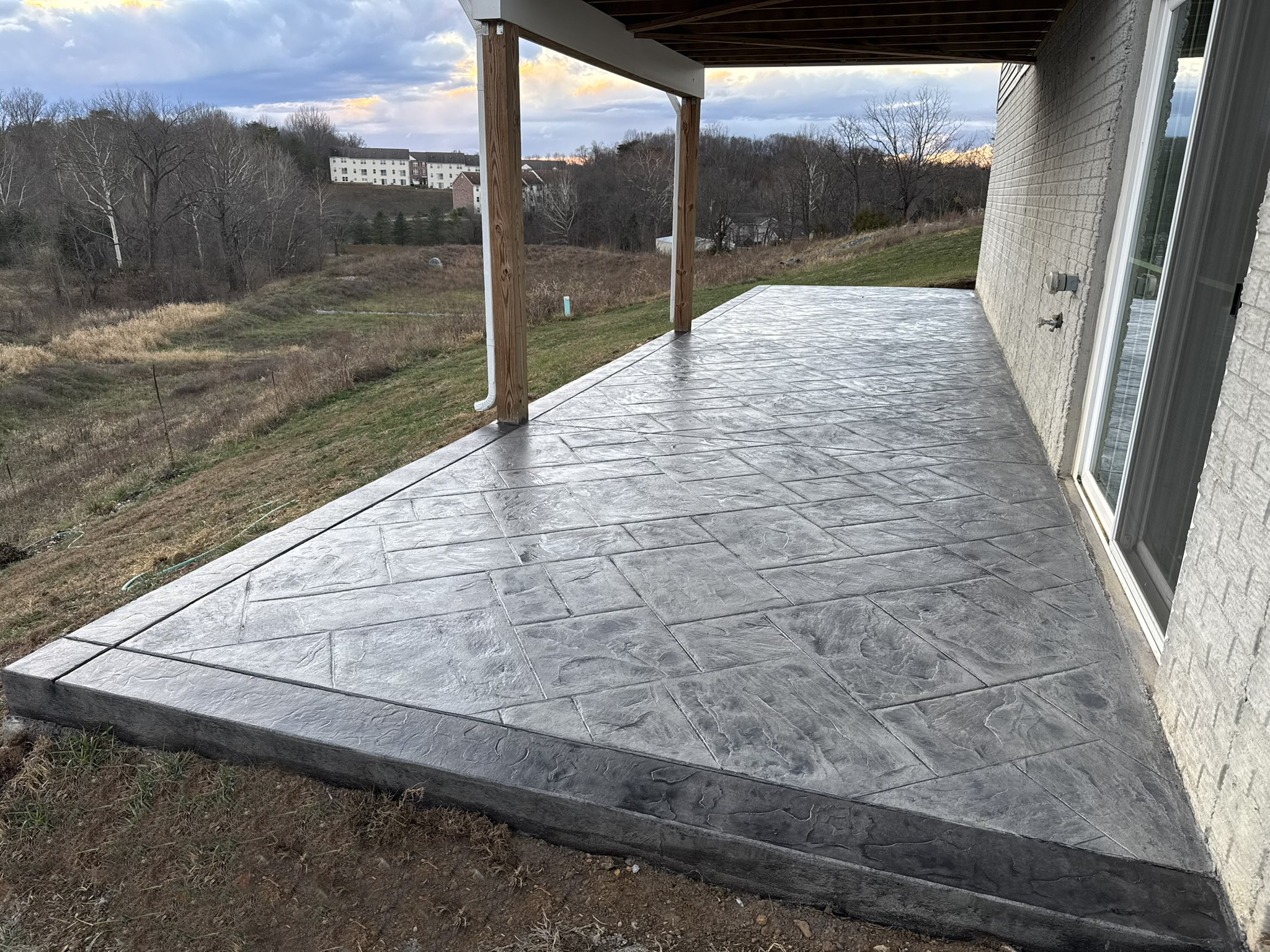 Large new stamped concrete patio in grey Majestic Ashlar with charcoal ...